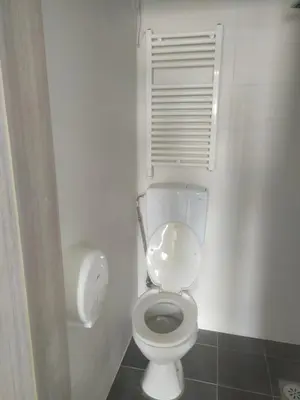 a bathroom with a white toilet and a window at SOVA smart HOUSE in Bar