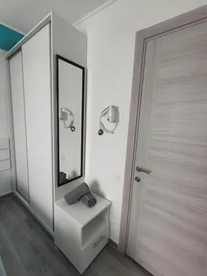 a white bathroom with a mirror and a sink at SOVA smart HOUSE in Bar