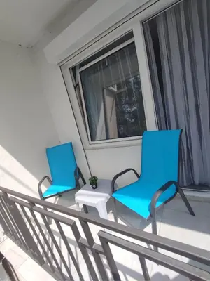 two blue chairs and a table on a balcony at SOVA smart HOUSE in Bar