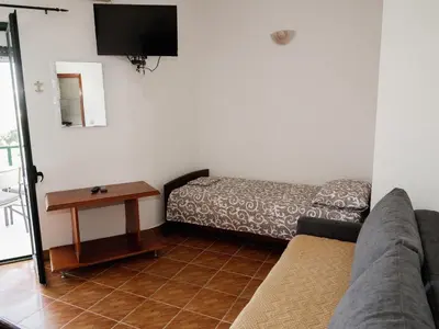 a living room with a couch and a table at Kashoxha Apartments with SeaView in Ulcinj