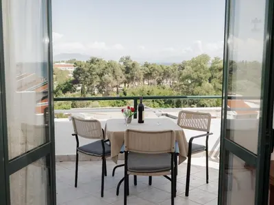 a table and chairs on a balcony with a view at Kashoxha Apartments with SeaView in Ulcinj