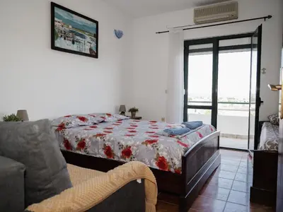 a bedroom with a bed and a couch at Kashoxha Apartments with SeaView in Ulcinj