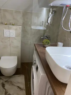 a bathroom with a white sink and a toilet at Apartman Senka in Budva
