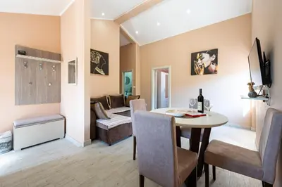 a living room with a table and a couch at Lara i Mirko Apartments in Mrčevac