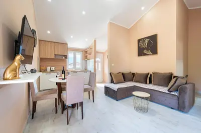 a kitchen and living room with a couch and a table at Lara i Mirko Apartments in Mrčevac
