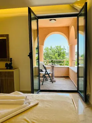 a bedroom with a glass door leading to a balcony at Luxury Villa Ulcinj in Ulcinj