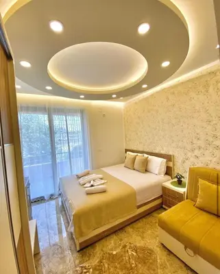 a bedroom with a bed and a couch in it at Luxury Villa Ulcinj in Ulcinj
