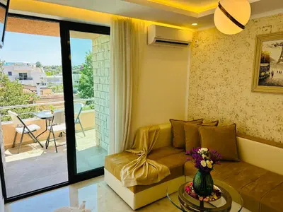 a living room with a couch and a balcony at Luxury Villa Ulcinj in Ulcinj