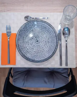 a plate and utensils sitting on a table at Luxury modern apartment 8min walk from beach in Becici in Rafailovici