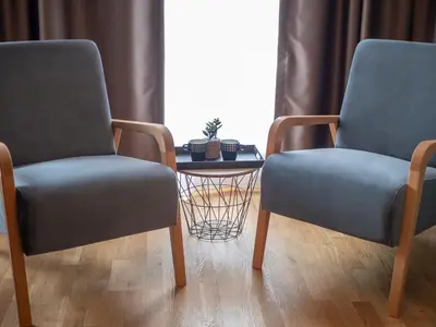 two chairs and a table in a room at Luxury modern apartment 8min walk from beach in Becici in Rafailovici