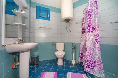 a bathroom with a toilet and a sink at Altomare with Sea View in Petrovac na Moru