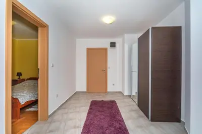 a room with a hallway with a door and a refrigerator at Altomare with Sea View in Petrovac na Moru