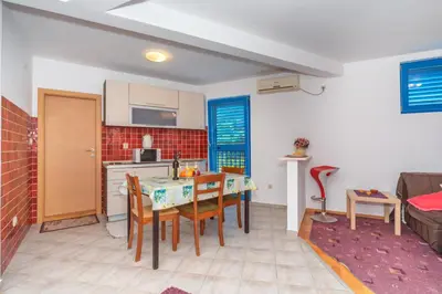 a kitchen and dining room with a table and chairs at Altomare with Sea View in Petrovac na Moru