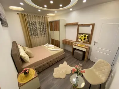 a hotel room with a bed and a mirror at Luxury Apartments in Ulcinj