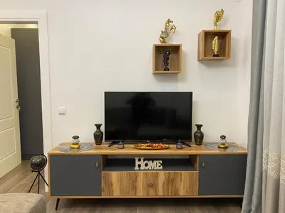 a living room with a flat screen tv on a entertainment center at Luxury Apartments in Ulcinj