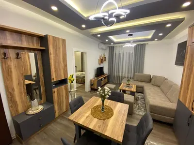 a living room with a couch and a table at Luxury Apartments in Ulcinj