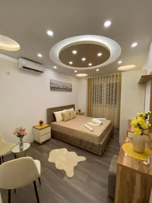 a bedroom with a bed and a living room at Luxury Apartments in Ulcinj