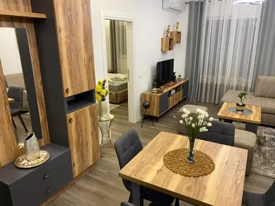 a living room with a table and a living room at Luxury Apartments in Ulcinj