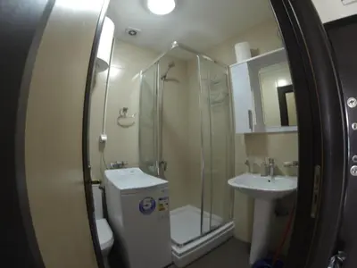 a bathroom with a shower and a toilet and a sink at Aegean home budva vojvodanska 16 b stan7 in Budva