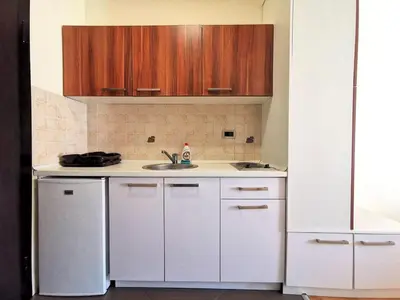 a kitchen with white cabinets and a sink at Aegean home budva vojvodanska 16 b stan7 in Budva