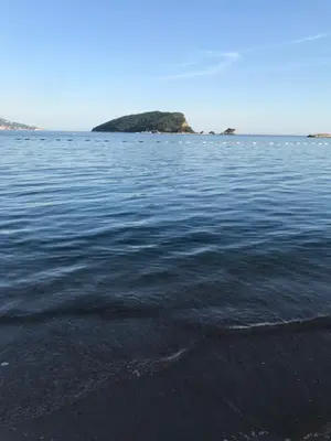 a body of water with an island in the distance at Aegean home budva vojvodanska 16 b stan7 in Budva