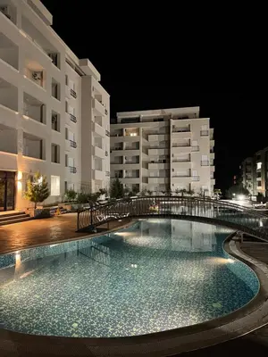 a swimming pool in front of a building at night at Apartment SONJA in Ulcinj