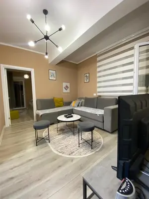 a living room with a couch and a tv at Apartment SONJA in Ulcinj