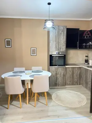 a kitchen and dining room with a table and chairs at Apartment SONJA in Ulcinj