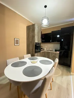 a dining room with a white table and chairs at Apartment SONJA in Ulcinj