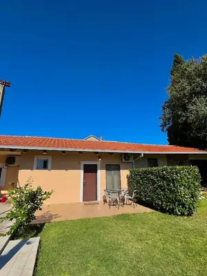 a house with a table and chairs in the yard at Apartman Boljević in Podgorica