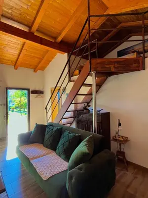 a living room with a couch and a staircase at Apartman Boljević in Podgorica