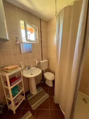 a small bathroom with a toilet and a sink at Apartman Boljević in Podgorica