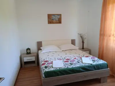 a bedroom with a bed with two towels on it at Villa Elena Zagora in Neodi