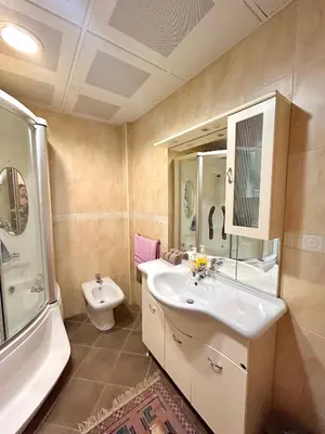 a bathroom with a sink and a toilet at Beach Bliss Apartment in Pržno