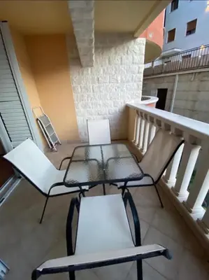 two chairs and a table on a balcony at Beach Bliss Apartment in Pržno
