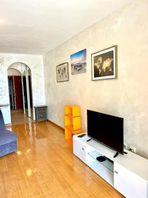 a living room with a flat screen tv at Beach Bliss Apartment in Pržno