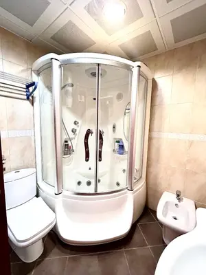 a small bathroom with a shower and a toilet at Beach Bliss Apartment in Pržno