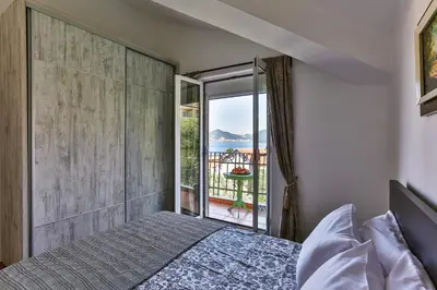 a bedroom with a bed and a view of the ocean at BARBARA SVETI STEFAN in Sveti Stefan