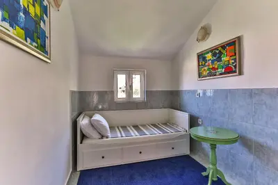 a small room with a bench and a table at BARBARA SVETI STEFAN in Sveti Stefan
