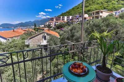 a bowl of fruit on a table on a balcony at BARBARA SVETI STEFAN in Sveti Stefan