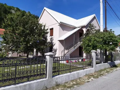 a white house with a black fence at Ivana in Cetinje