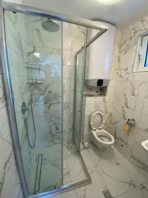 a bathroom with a shower and a toilet at Villa Lime in Petrovac na Moru