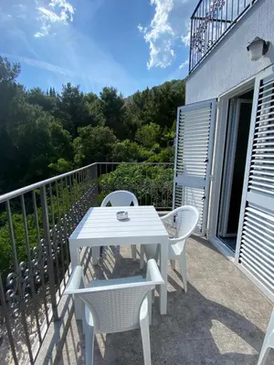 a white table and chairs on a balcony at Villa Lime in Petrovac na Moru