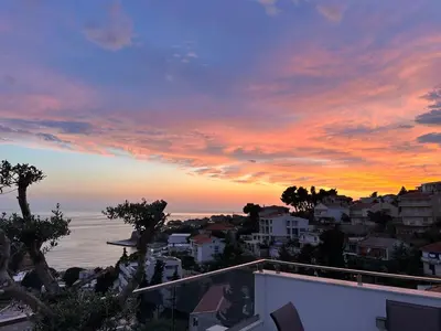 a sunset view of the ocean from a house at CASA BIANCA & Spa 2 in Ulcinj