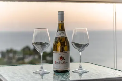 a bottle of wine and two wine glasses on a table at CASA BIANCA & Spa 2 in Ulcinj