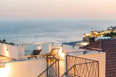 a balcony with two chairs and a view of the ocean at CASA BIANCA & Spa 2 in Ulcinj
