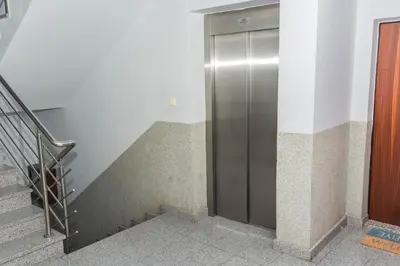 a metal elevator in a building with a staircase at Bobo Apartment in Budva
