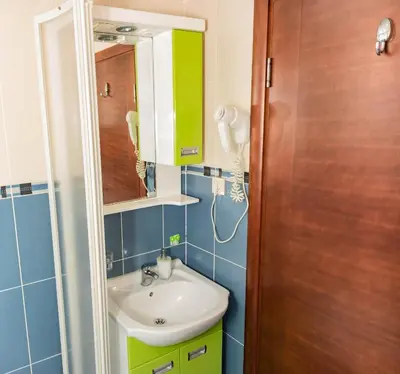 a bathroom with a sink and a mirror at Bobo Apartment in Budva
