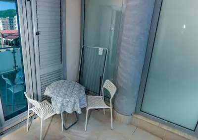 a table and two chairs on a balcony at Bobo Apartment in Budva
