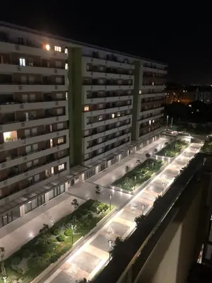 a view of a large apartment building at night at Stan Central point Podgorica in Podgorica